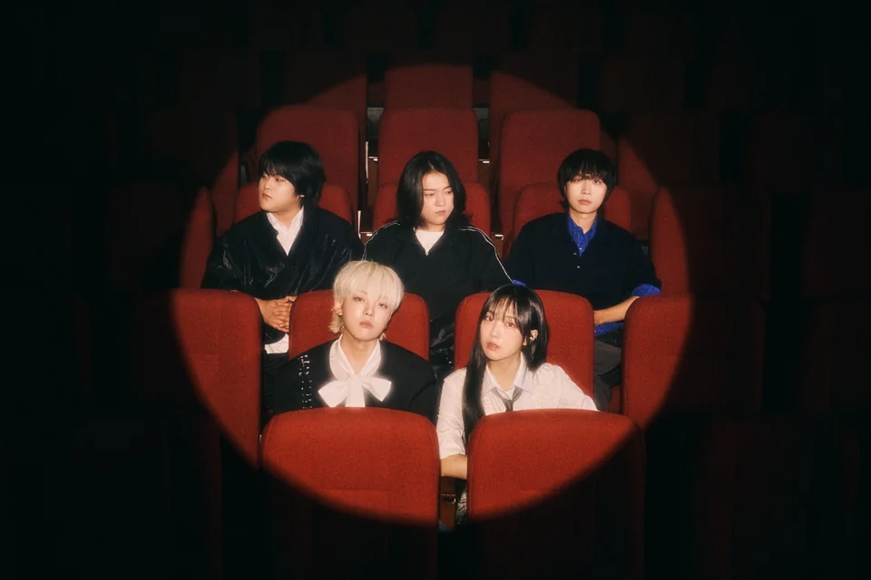 The five members of YdBB seated in red cinema chairs